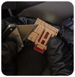 Gloved hands holding the male end of the tail light plug with the centre tab trimmed off with a razor blade