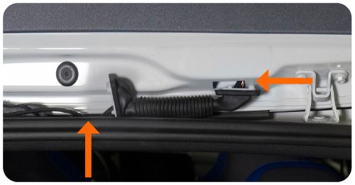 Arrows showing the bottom grommet pushed upwards and the top grommet pushed downwards