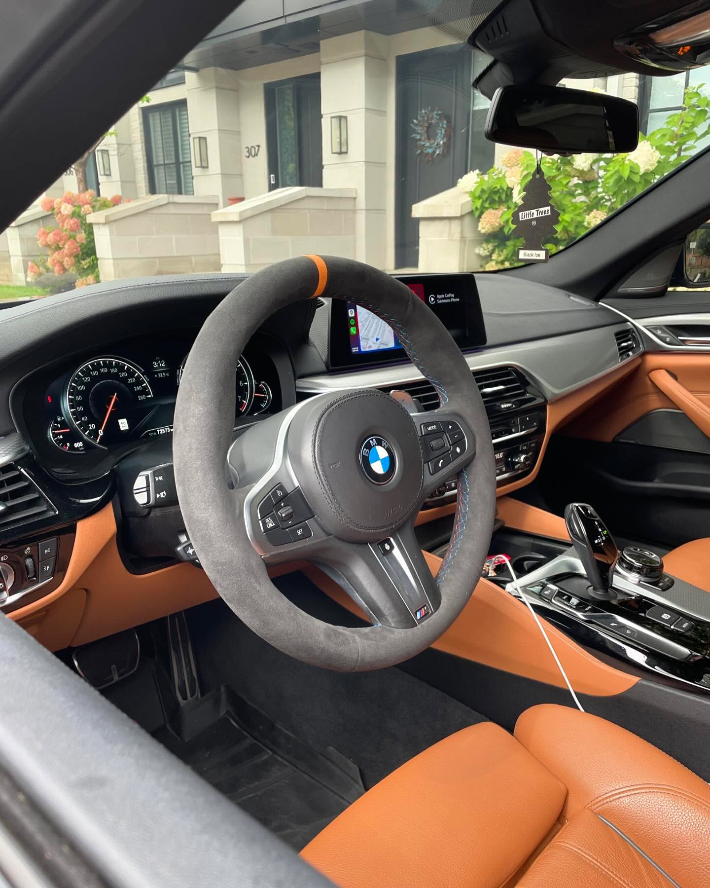 Custom carbon and Alcantara steering wheel fitted to a cognac leather interior